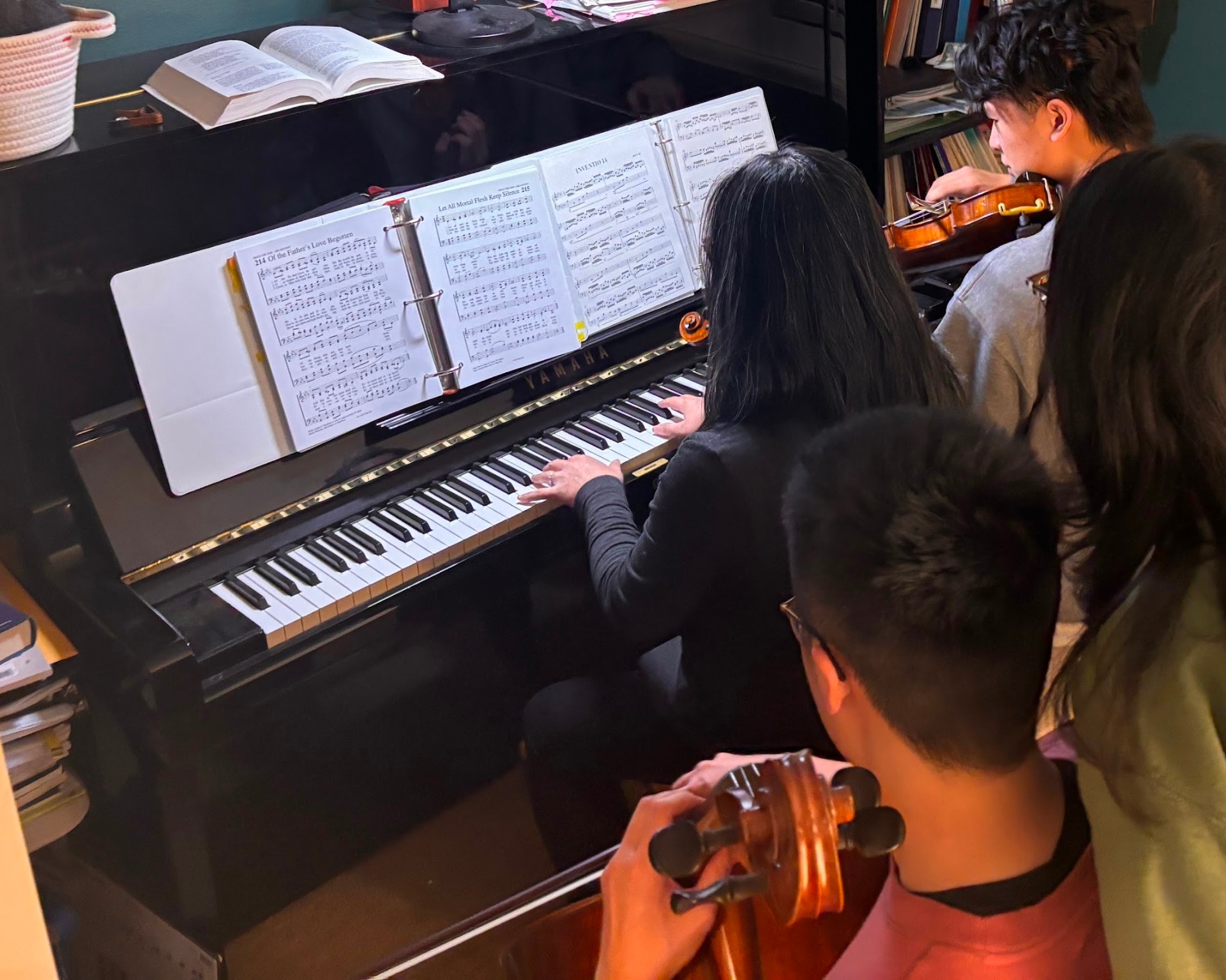 Two students collaborating at the piano during an ensemble lesson at Fallbrooke Piano Academy